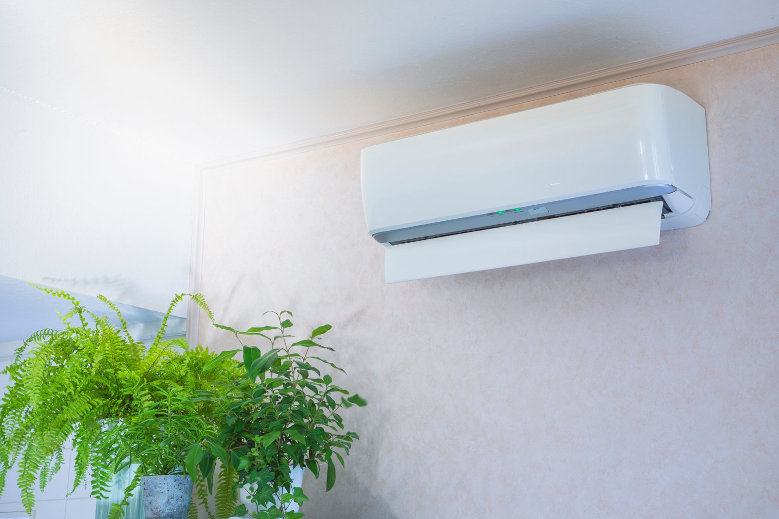 Wall-mounted split air conditioner in a modern interior, actively cooling the room with fresh airflow.